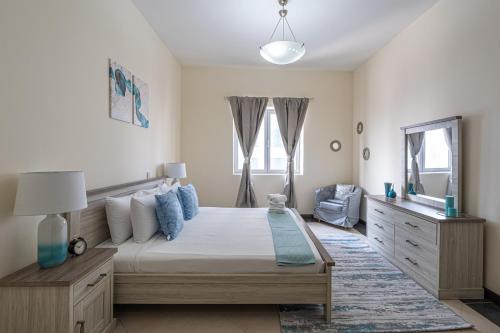 a bedroom with a large bed and a mirror at HiGuests - Large Apt in the Heart of Deira Near Clocktower in Dubai