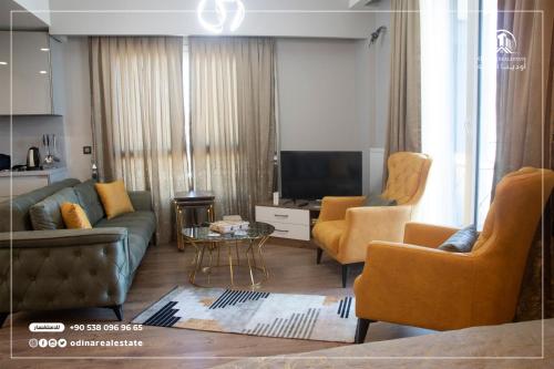 a living room with a couch and chairs and a television at luxury holiday in the heart of istanbul in Istanbul