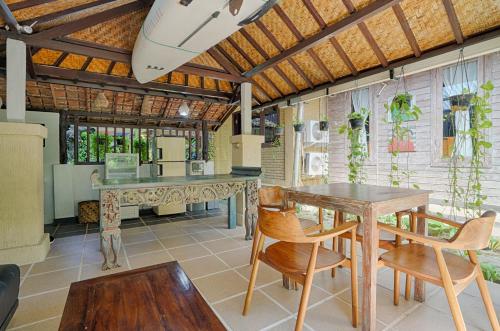 a dining room with a table and chairs at Katang - Katang Guest House in Denpasar