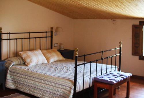 a bedroom with a bed and a wooden ceiling at El Celler de la Guàrdia in Montserrat