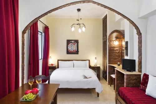 a hotel room with a bed and a table at Galatia Villas in Fira