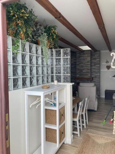 a room with a white table and a dining room at Casa de los abuelos 6 personas in Olvera