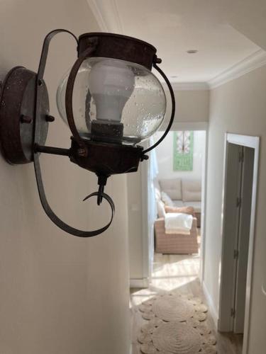a light hanging on a wall in a room at Casa de los abuelos 6 personas in Olvera