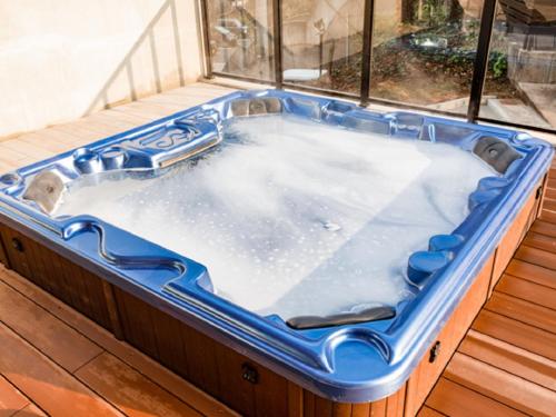 a jacuzzi tub sitting on top of a deck at LiVEMAX RESORT Miyahama Ocean View in Hatsukaichi