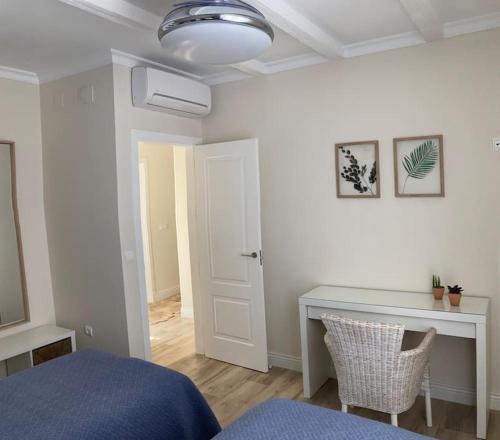 a bedroom with a bed and a desk in it at Casa de los abuelos 6 personas in Olvera