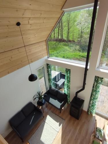 an overhead view of a living room with a large window at Stodoły Hołosanka 600-065-145 in Polańczyk