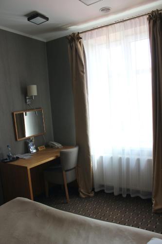 a hotel room with a desk and a window at Kolobok in Luts'k