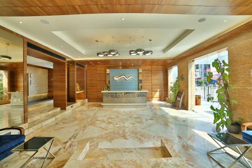 a lobby of a hotel with a marble floor at HOTEL G EXPRESS Formerly Known as TGB Express in Ahmedabad