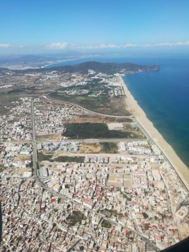 an aerial view of a city next to the beach at Riad Salt River in Martil