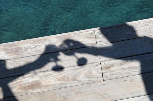 a shadow of a street light on a wooden deck at Apres La Sieste in Saint-Laurent-des-Arbres