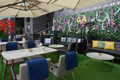 a restaurant with tables and chairs and a wall of flowers at Pullman London St Pancras in London