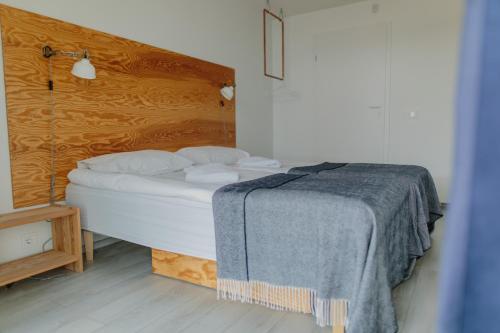 מיטה או מיטות בחדר ב-Smiltynės Jachtklubas
