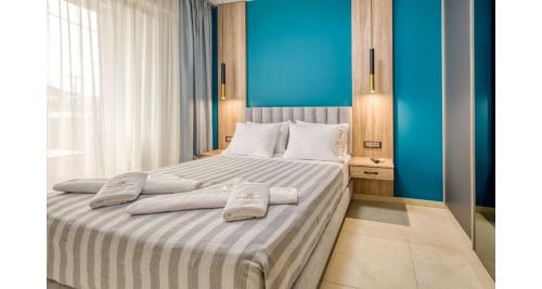 a bedroom with a large bed with towels on it at Sapphire Horizon Suites in Kissamos