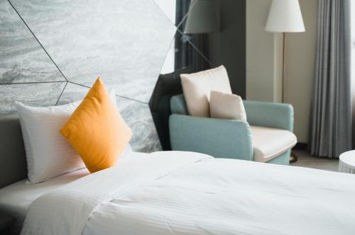 Una cama o camas en una habitación de Xien Shi Homestay