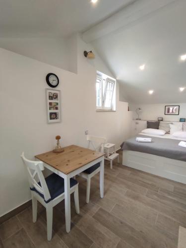 a bedroom with a bed and a table and chairs at House Valun 42 in Valun