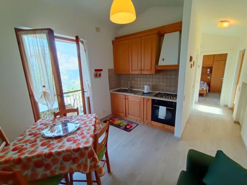 a kitchen and dining room with a table and chairs at Lorena house in Brenzone sul Garda