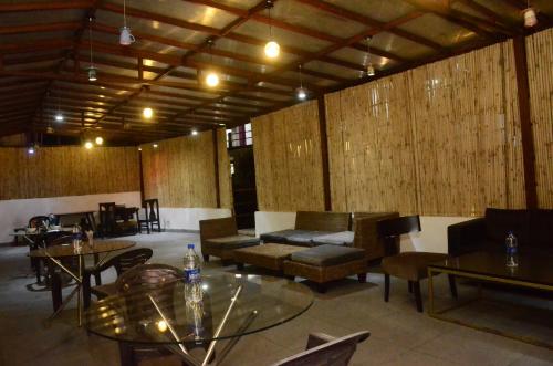 a large room with tables and couches and chairs at The Golden Sunrise Hotel in Nainital