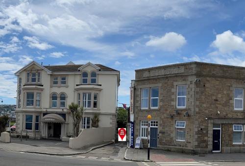 two buildings sitting next to each other on a street at Guest Lodge Penzance in Penzance