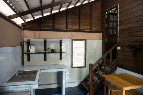 a kitchen with a stove top oven and a sink at Sabai Corner Bungalows - SHA Extra Plus in Ko Yao Noi