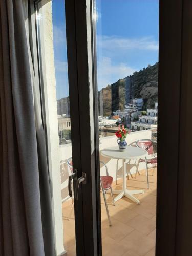a view from a door of a balcony with a table at Ostria in Agia Galini