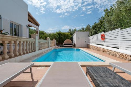 a swimming pool in the backyard of a house at Villa Luca in Cala d´Or