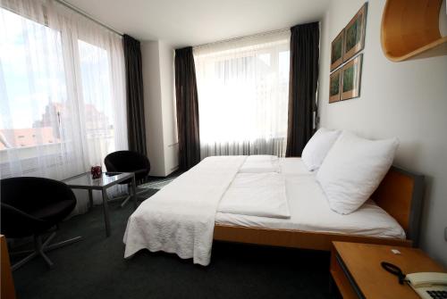 Postel nebo postele na pokoji v ubytování Hotel Central