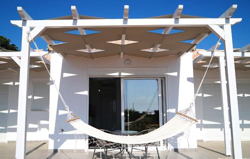 a hammock on the front porch of a house at Ktima Ayia Marina in Amalias