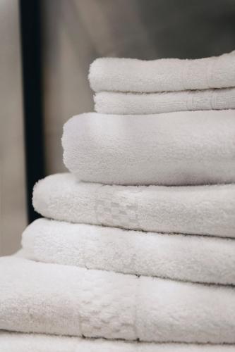 a stack of white towels stacked on top of each other at Dock 1 Boutique Hotel in Cospicua