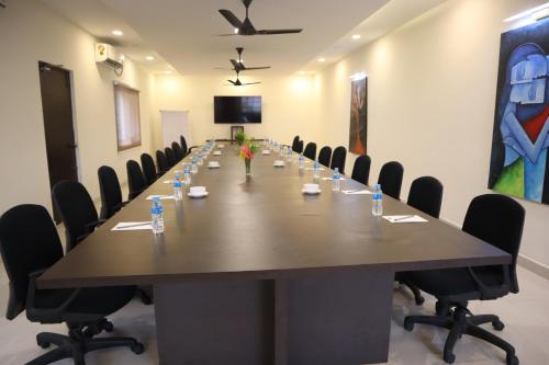 a large conference room with a long table and chairs at Royal Destiny Resort in Malaiyāndipattanam