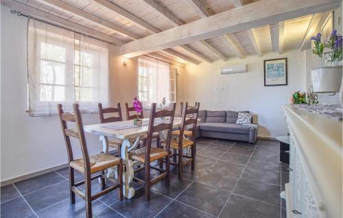 a kitchen and dining room with a table and chairs at Lovely Home In Santa Maria Albiano in Santa Maria Albiano