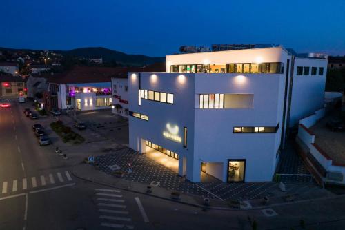 an overhead view of a white building at night at Hotel Boutique Aquarel in Zalău