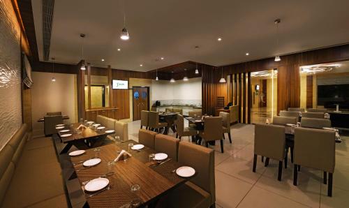 a dining room with wooden tables and chairs at Hotel Fortune in Rāmeswaram