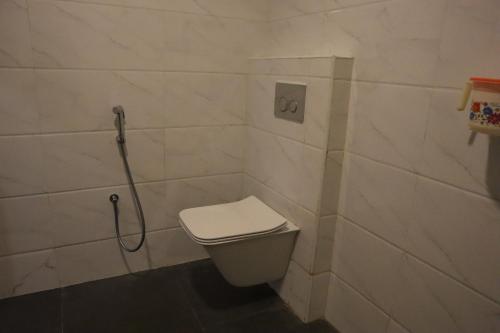 a bathroom with a toilet and a shower at Royal Destiny Resort in Malaiyāndipattanam