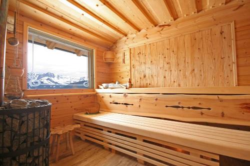a sauna with a bench in a wooden cabin at Almliesl BHOF-676 in Bischofshofen
