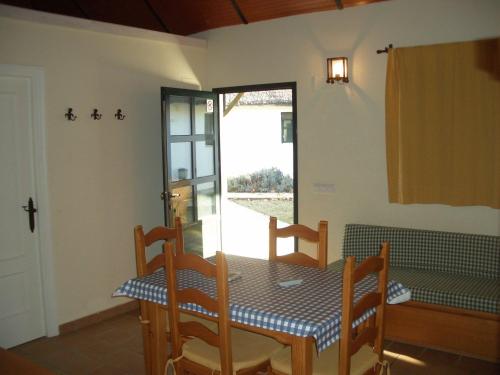 
a dining room table and chairs in a room at Camping La Aldea in El Rocío
