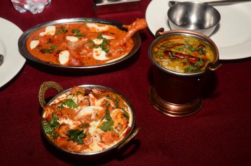 a table with two dishes of food on a table at The Golden Sunrise Hotel in Nainital