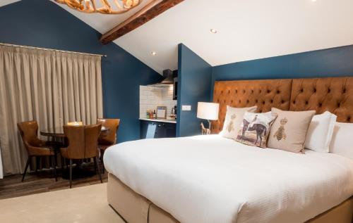 a bedroom with a large bed and a blue wall at The Hotel Chester in Chester