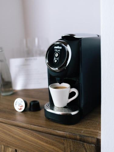 a coffee machine sitting on a counter with a cup of coffee at Harding Boutique Hotel in Ahangama