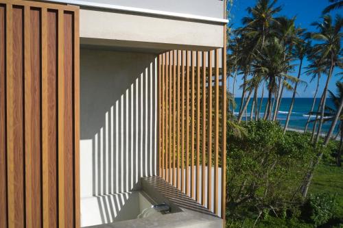 a house with a wooden door and a stairway at Harding Boutique Hotel in Ahangama
