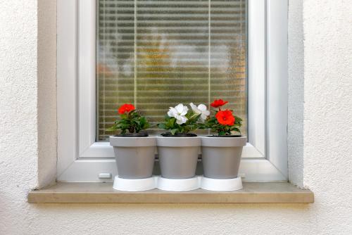 three flower pots sitting on a window sill at Studio Mare in Zadar