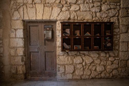 a stone wall with a door and a window at Corner Cavour Apartment in Sassari