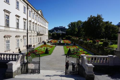 a walkway next to a building with a garden at Cocoon Salzburg in Salzburg
