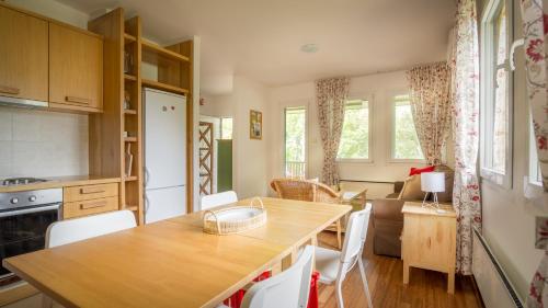 a kitchen and living room with a table and chairs at Vila Camelia in Golubac