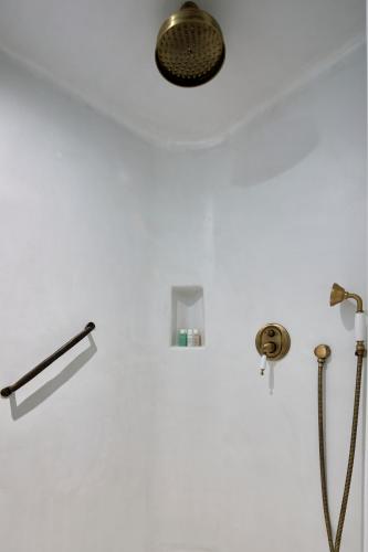 a bathroom with a shower with a shower head at Winery Hotel 1870 in Fira