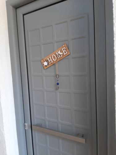 a door with a home sign on it at Ostria in Agia Galini