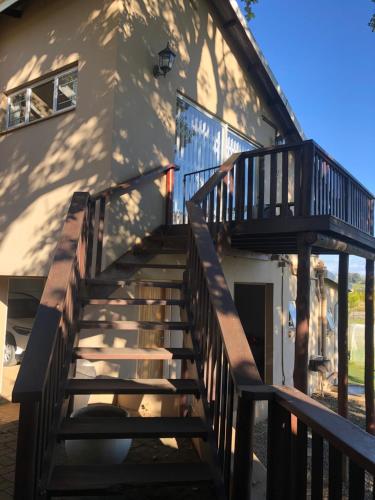 a staircase leading up to a house with a building at Bee’s Knees Cottage in Winterton