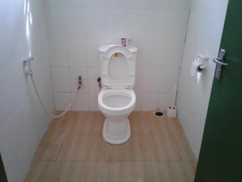 a small bathroom with a toilet in a stall at Fanaka Safaris Campsite & Lodges in Mto wa Mbu