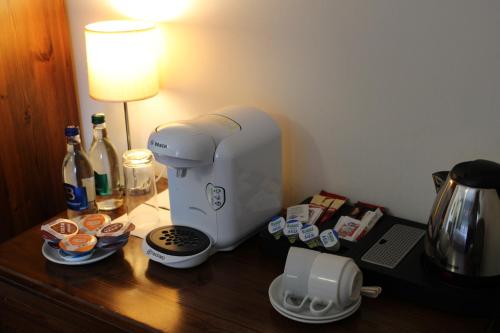 a coffee maker sitting on a table next to a lamp at Coach House Hotel Sligo in Ballymote