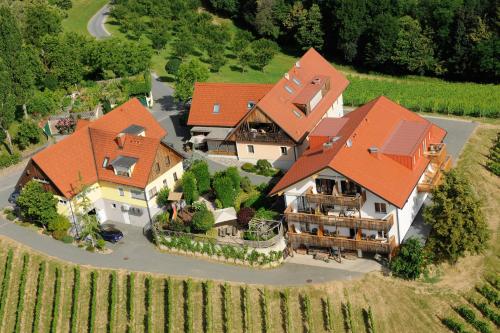 an aerial view of a large house with orange roofs at Weingut Dreisiebner Stammhaus in Gamlitz