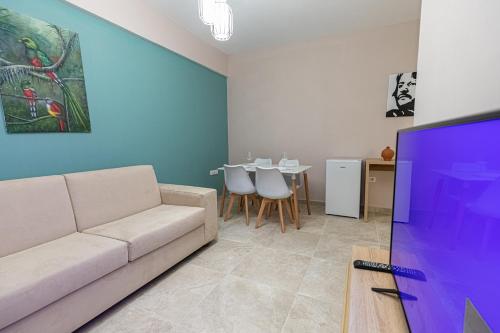 a living room with a couch and a tv at Villa The Old Bakery in Qeparo